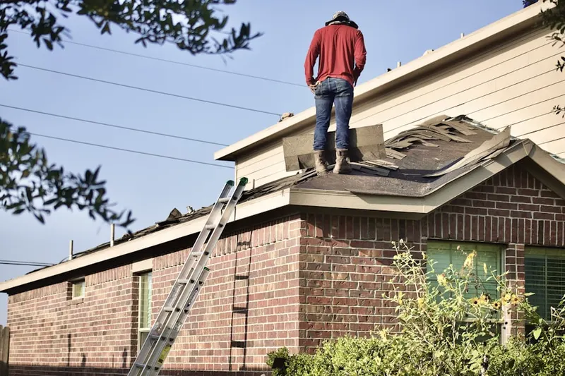 Professional roofer working on a residential roof in Crestview Meadows